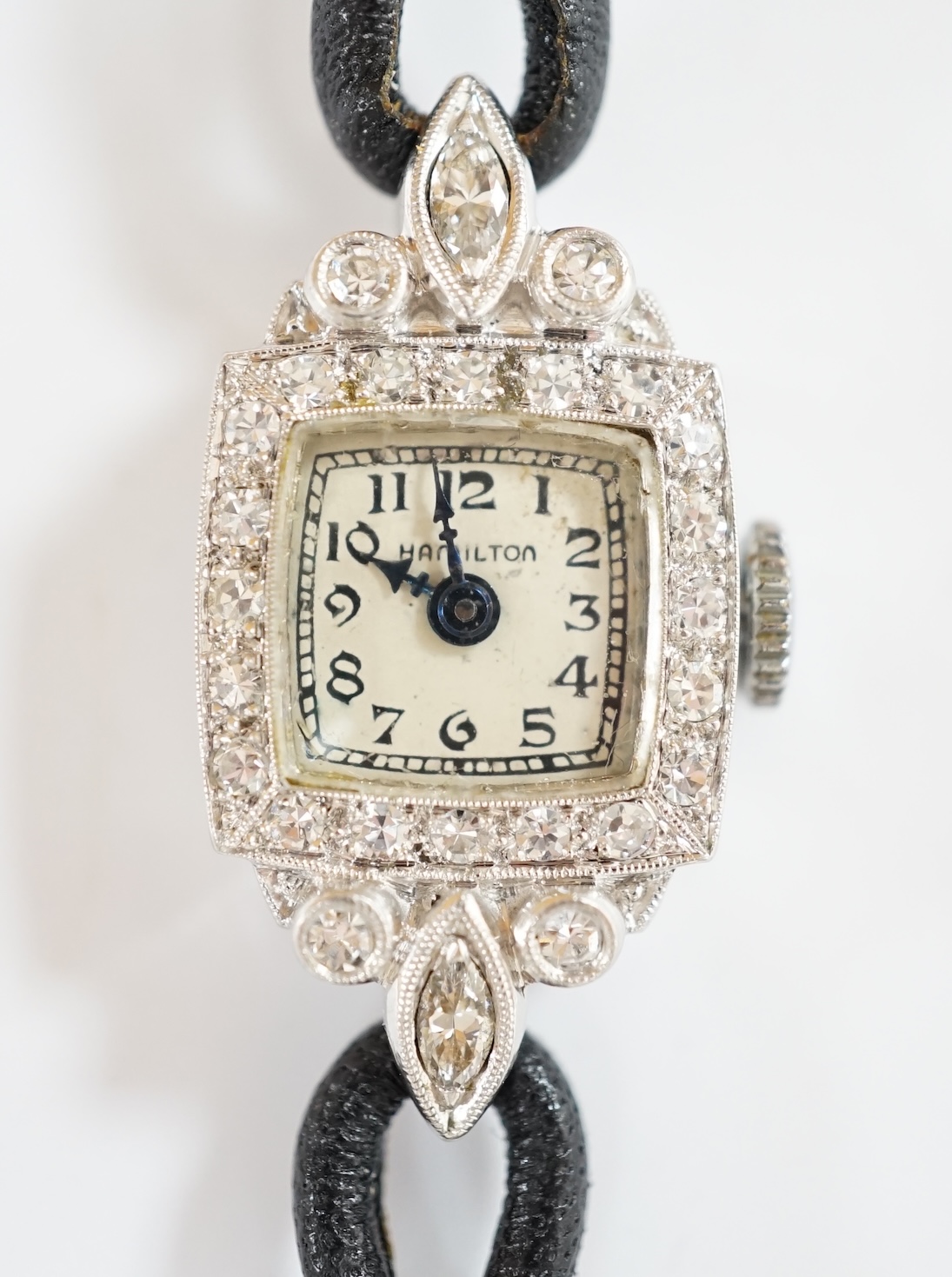 A lady's white metal (engraved plat irid 10%) and diamond set Hamilton manual wind cocktail watch, on a twin fabric strap. Condition - fair
